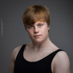 confidence, confident headshot, connection, dancer, dancer headshot, dancer portfolio, head shot, headshot, male dancer, performer headshot, spotlight headshot, spotlight profile image, strong headshot, studio headshot